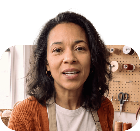 Portrait of a woman with curly hair in a cardigan