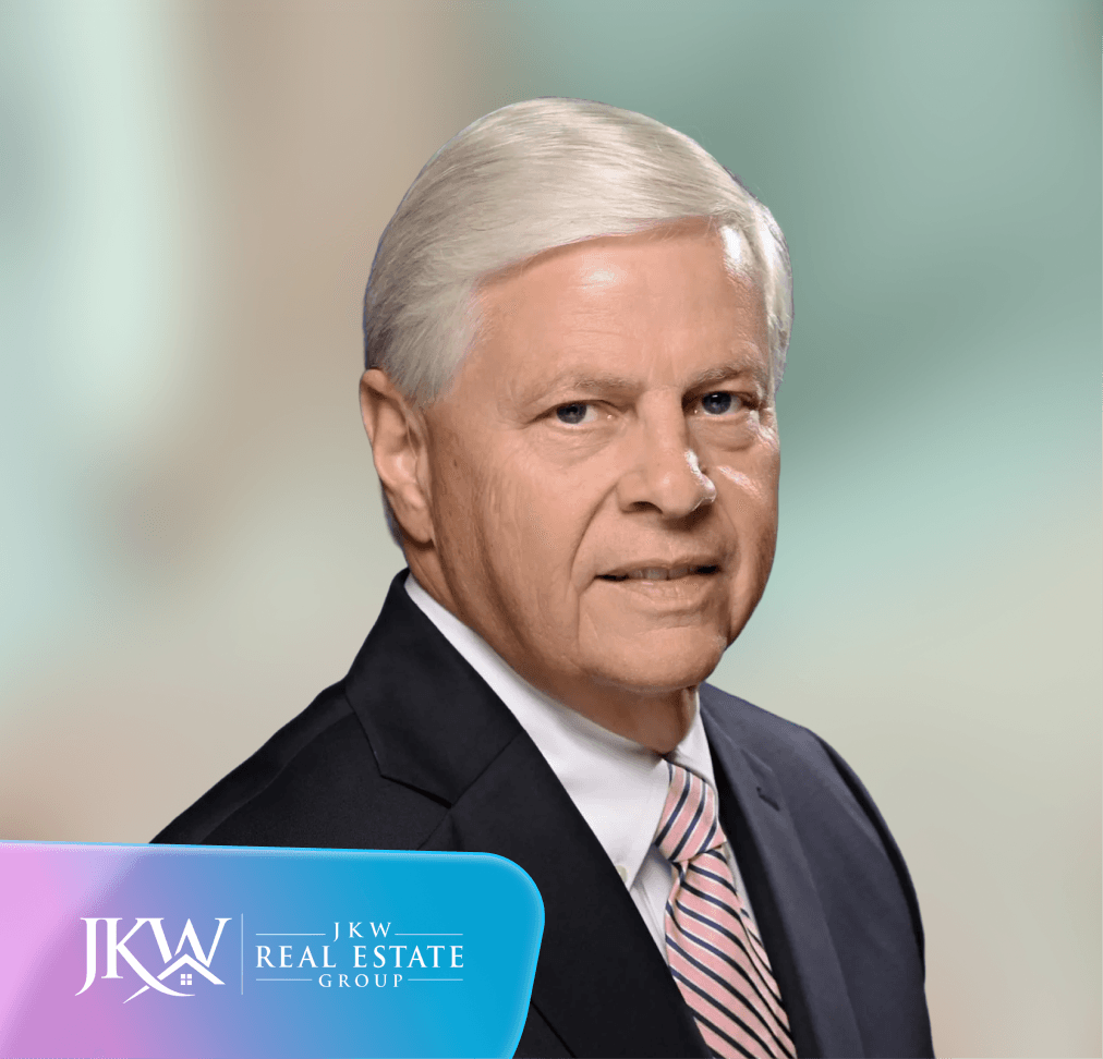 Портрет літнього чоловіка в костюмі та краватці з логотипом JKW Real Estate Group.