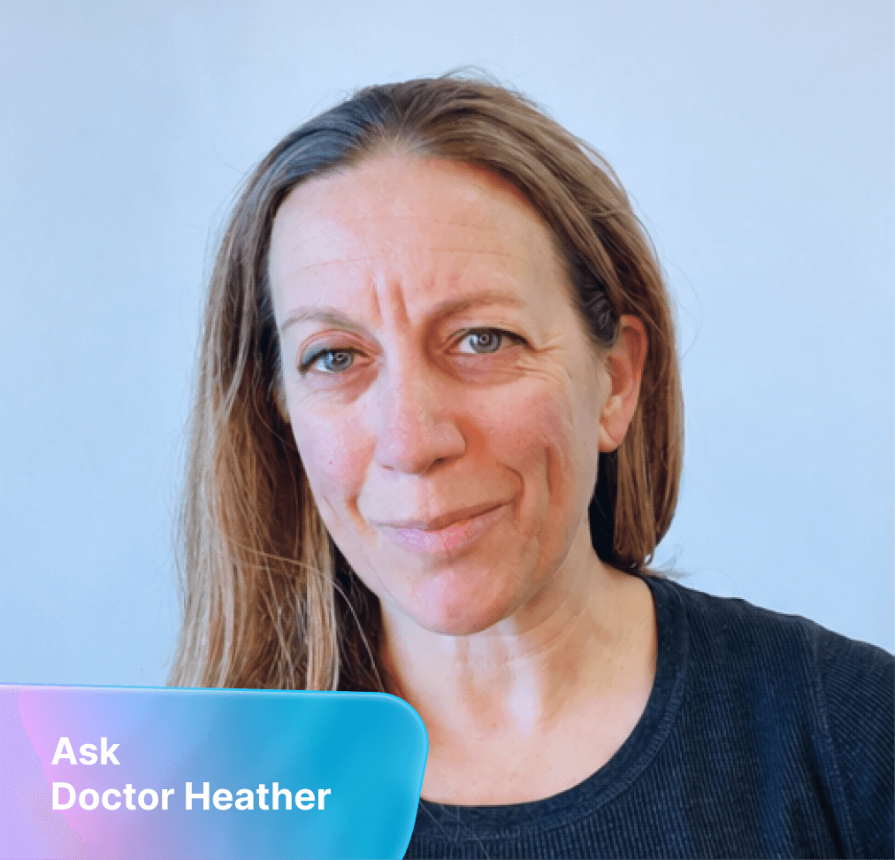 A woman with brown hair and blue eyes smiles slightly with furrowed brows. A colorful banner reads "Ask Doctor Heather".