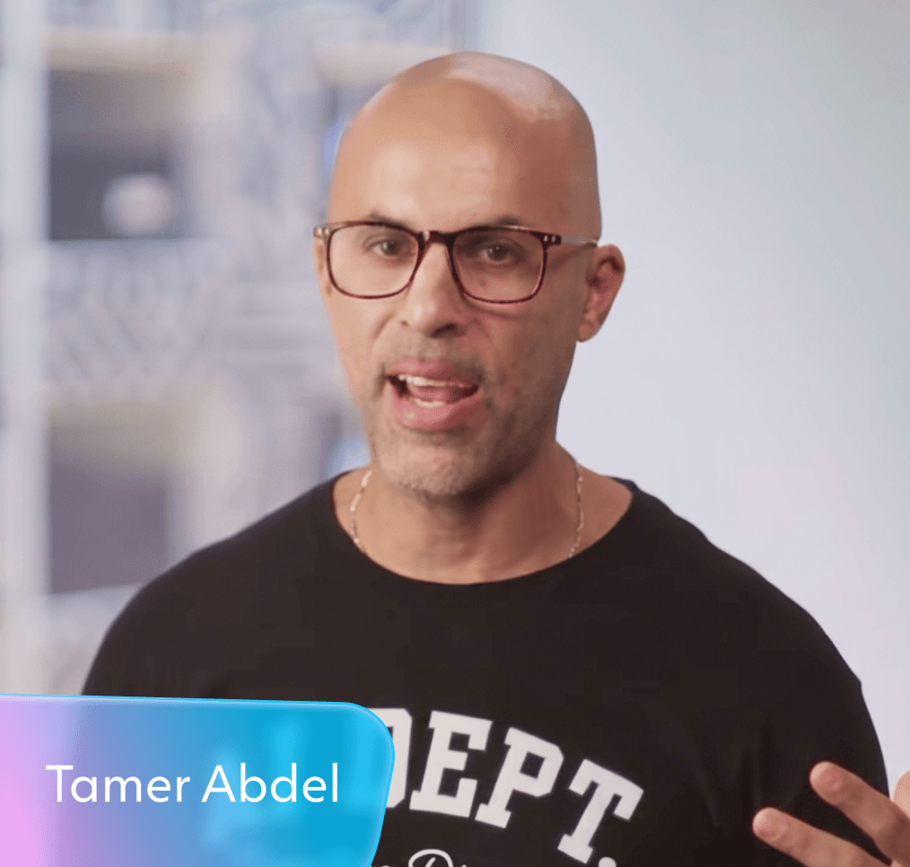 Tamer Abdel, a bald man with glasses, speaking.