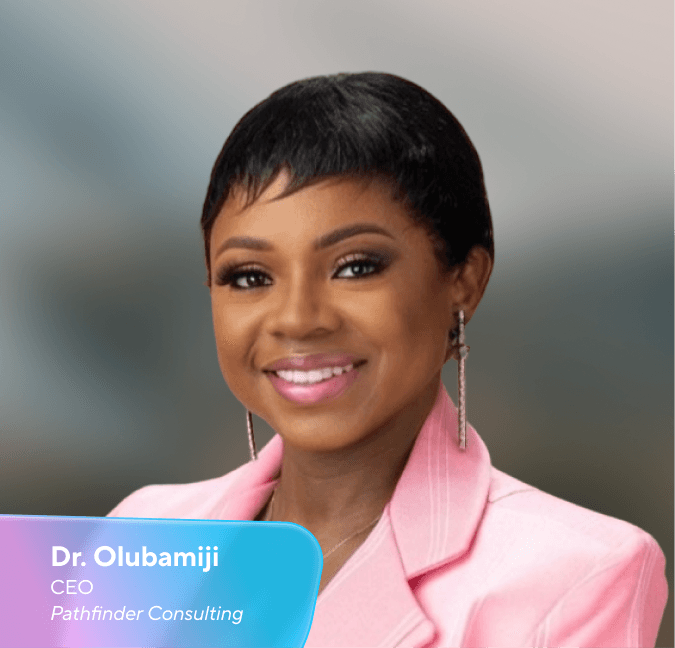 Headshot of Dr Olubamiji, CEO of Pathfinder Consulting, smiling in a pink blazer.