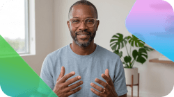 Smiling Black man with a beard and glasses gesturing with his hands.